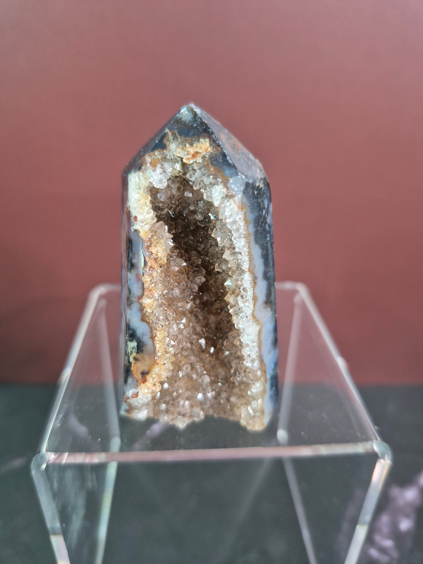 Geode crystal on a stand with a blurred background