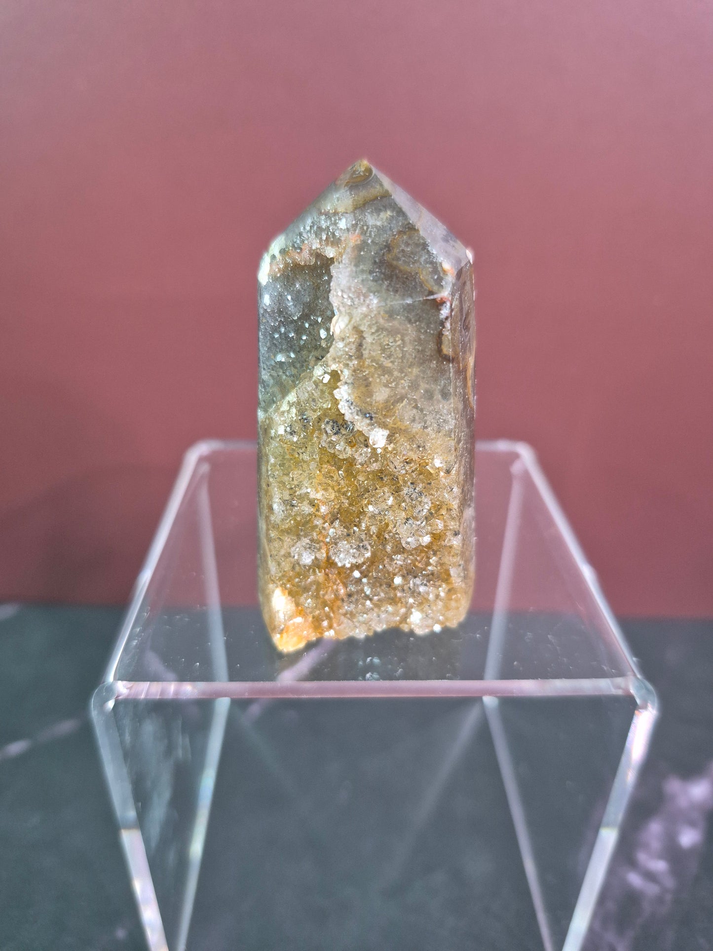 Crystal on a stand with a clear acrylic display case
